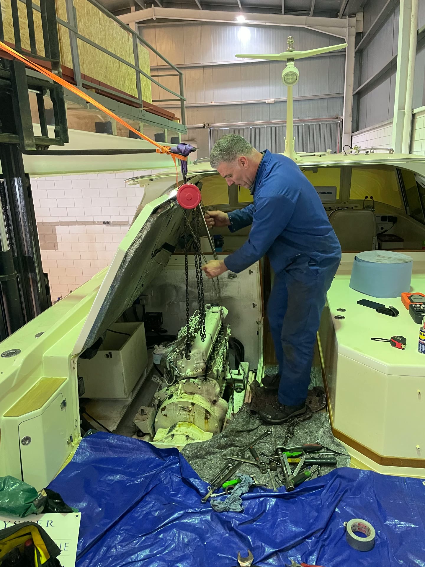 Engineer removing an engine from a motor yacht in the Tidal Marine workshop
