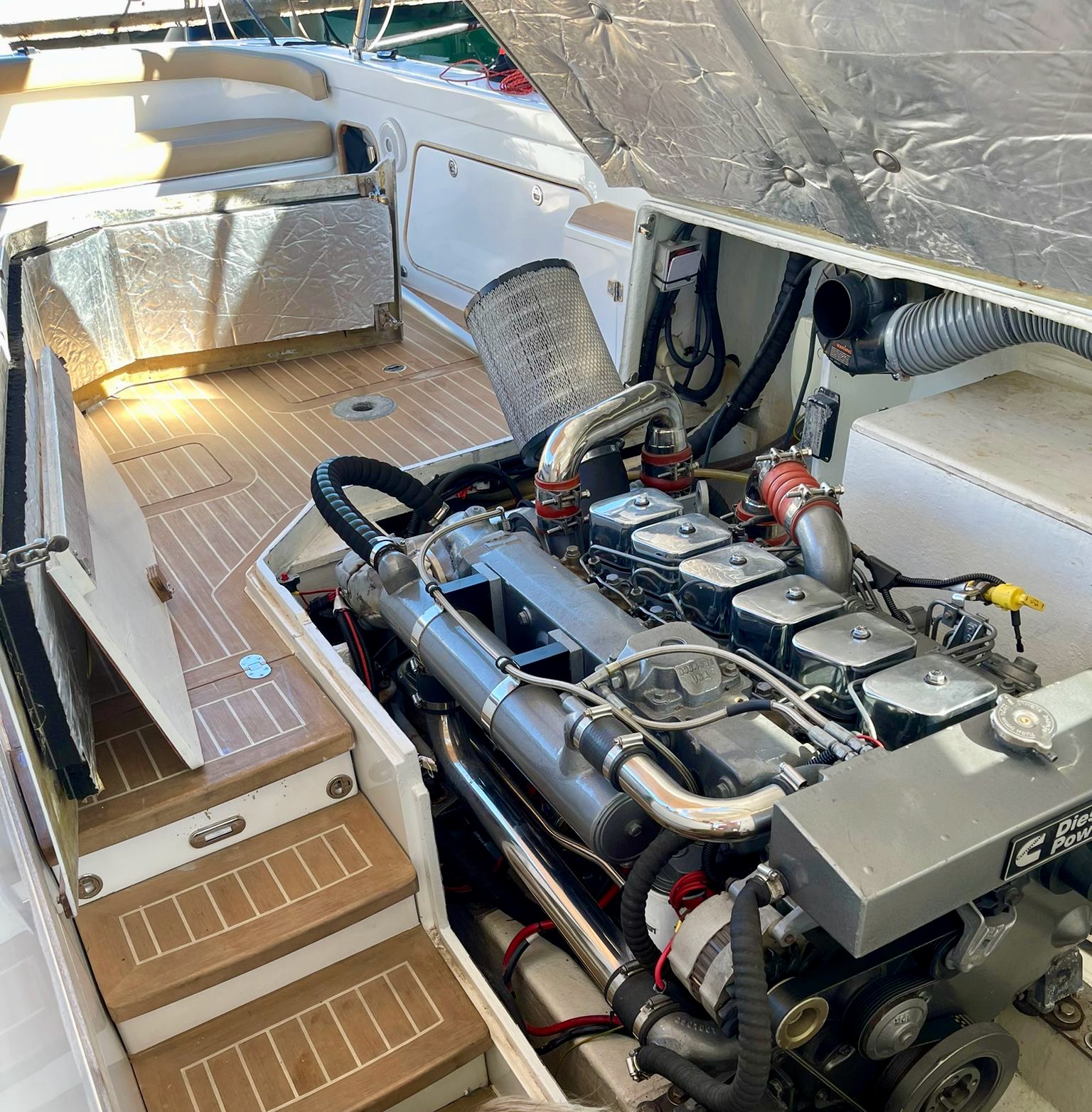 Custom Cummins 6BTA with chrome pipework installed in a Bertram 31
