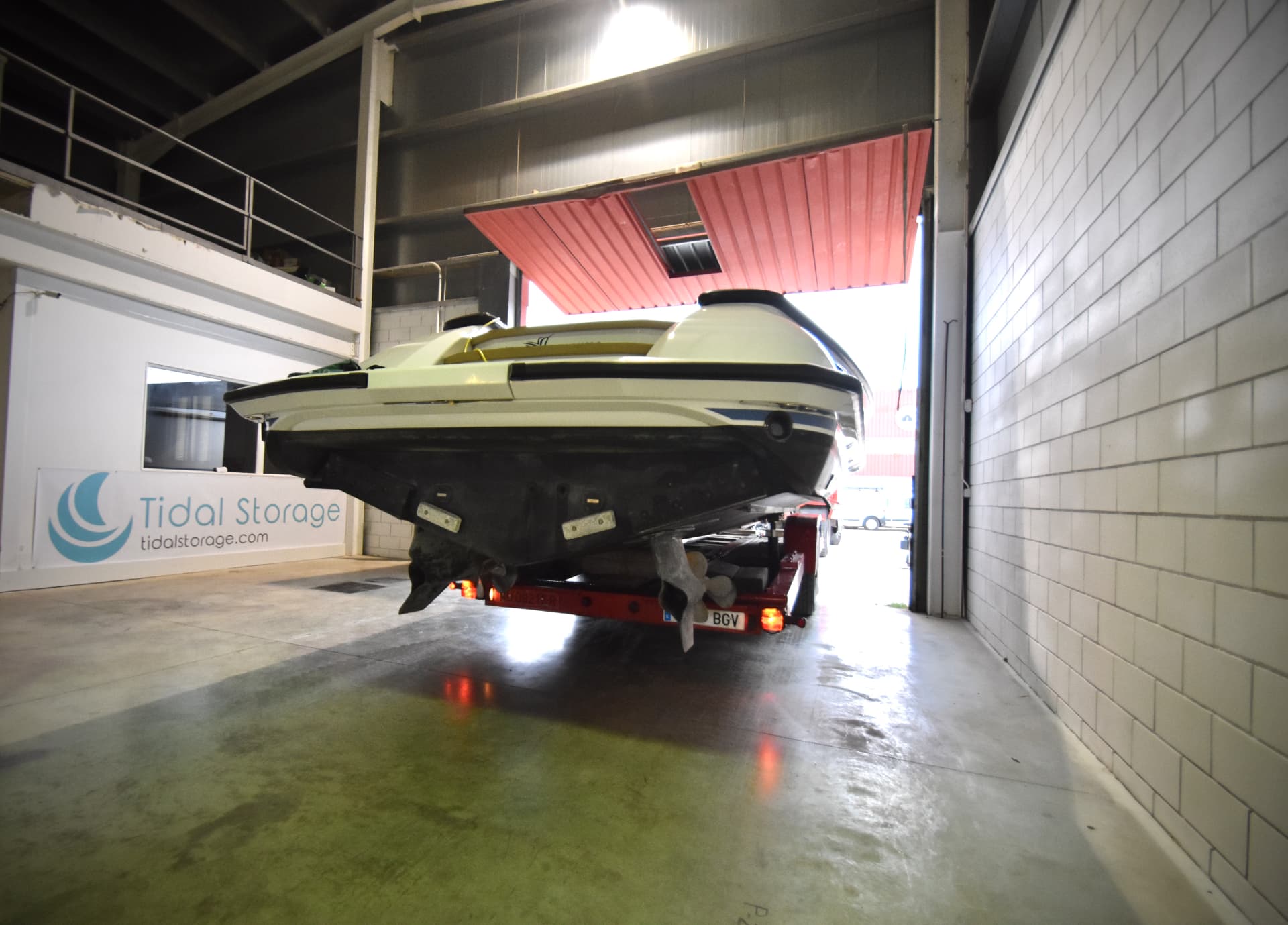 Covered day boat stored on a cradle in a dry, secure bay